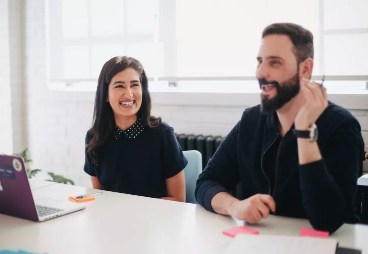 A photo of two legal professionals enjoying time in the office