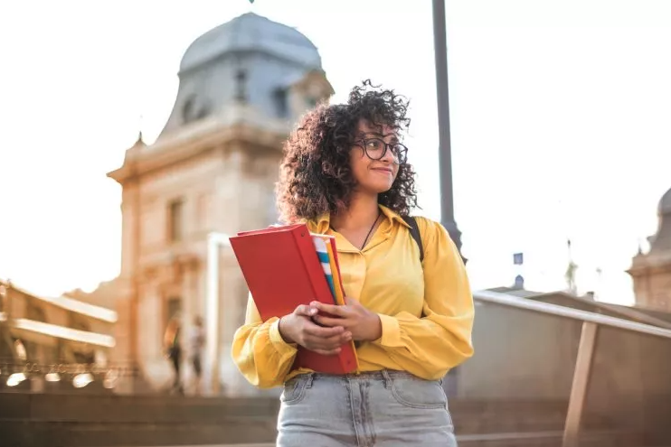 Student walking with books at university