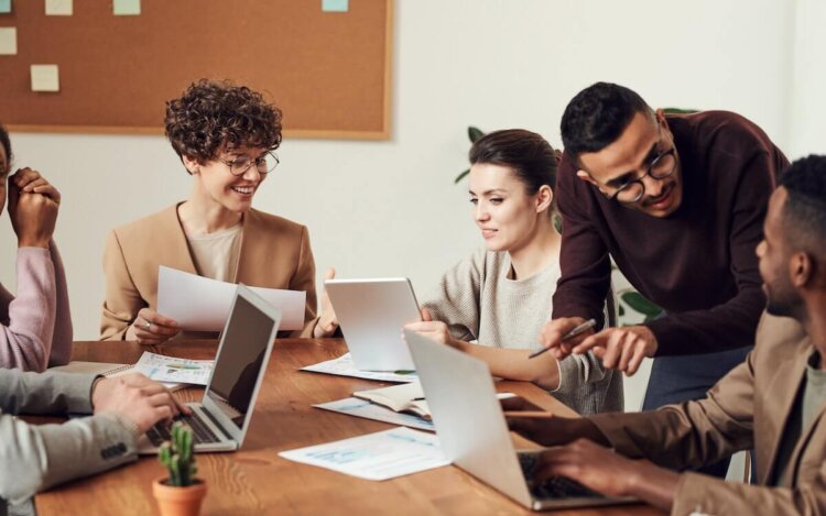 Can a non-lawyer own a law firms? Lawyers working together around a table.