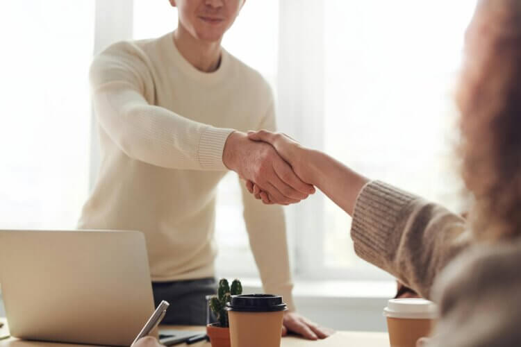 Image of an e-discovery lawyer at an interview shaking hands with interviewer